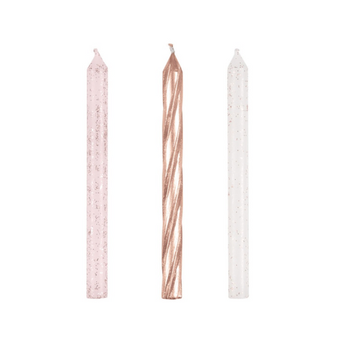 Three candles with different designs on a white background the package contains 24 candles 8 of each shown