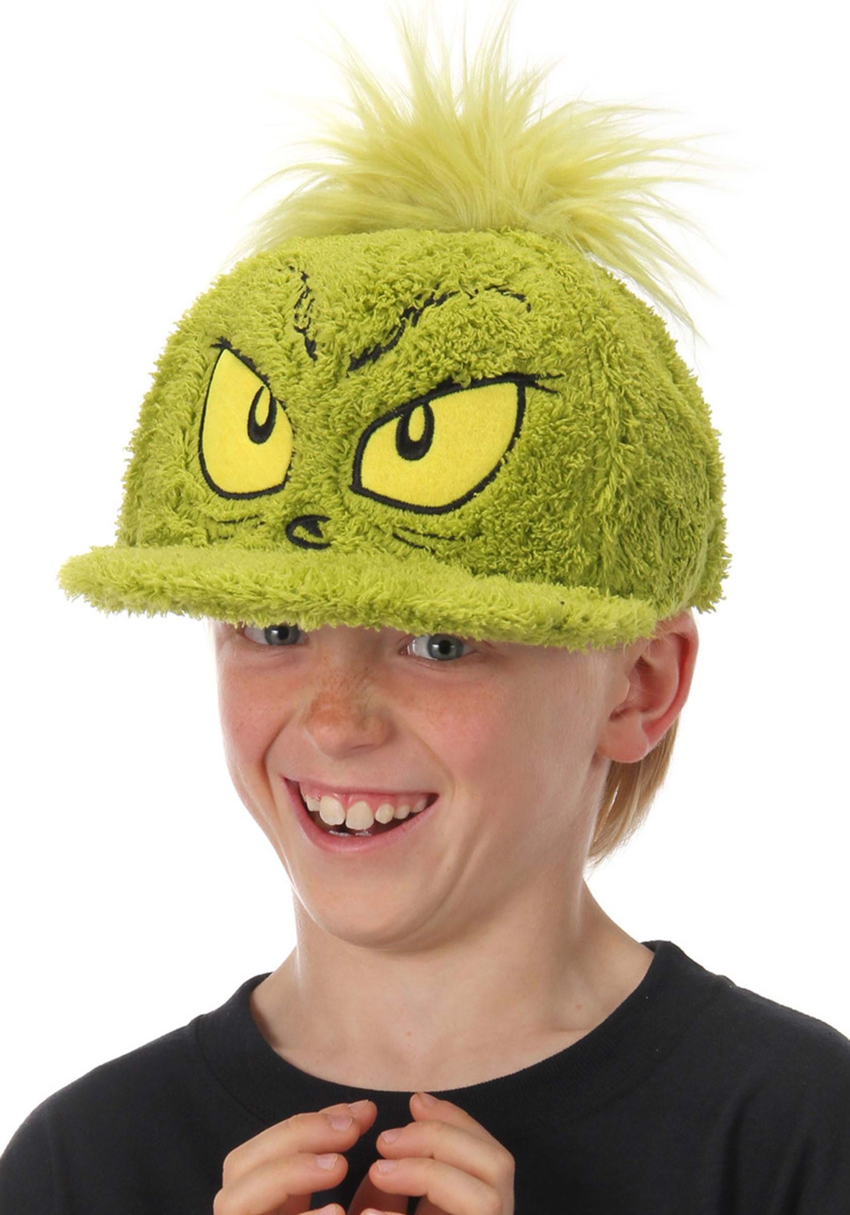 Child wearingOfficially licensed Dr. Seuss Grinch Fuzzy Cap with embroidered face. 