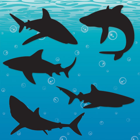Shark themed backdrop party setup with black silhouettes of sharks swimming underwater with bubbles on a blue background 