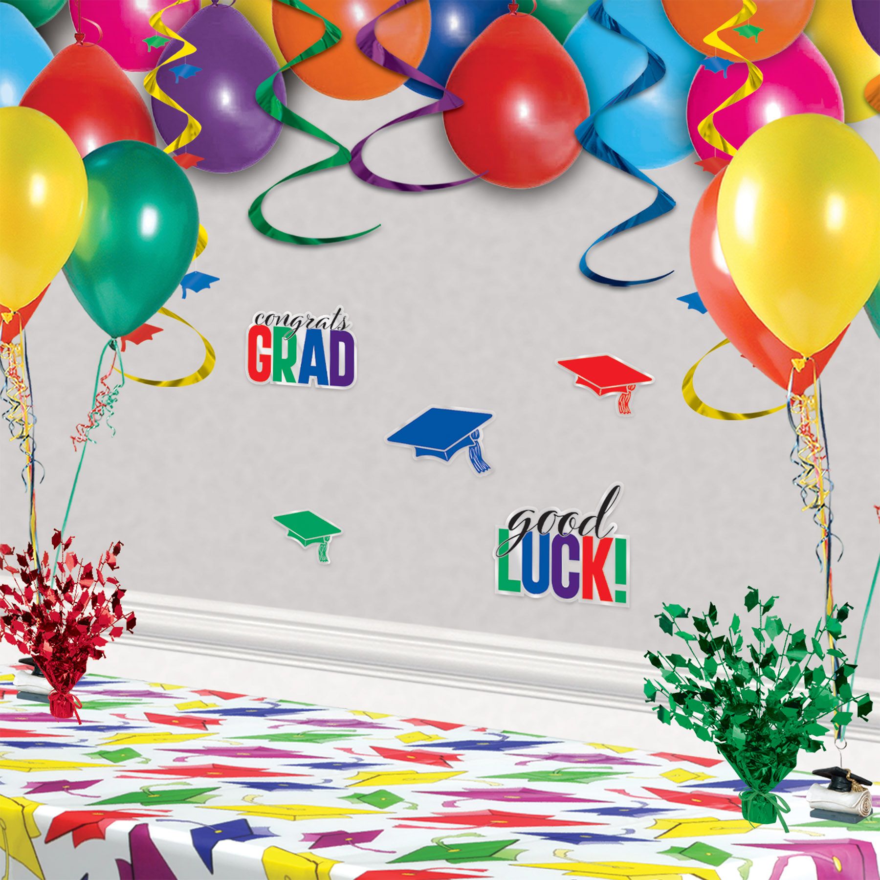 Plastic Congrats Grad cutouts in multicolor with sizes ranging from 5 to 9½ inches shown on a wall