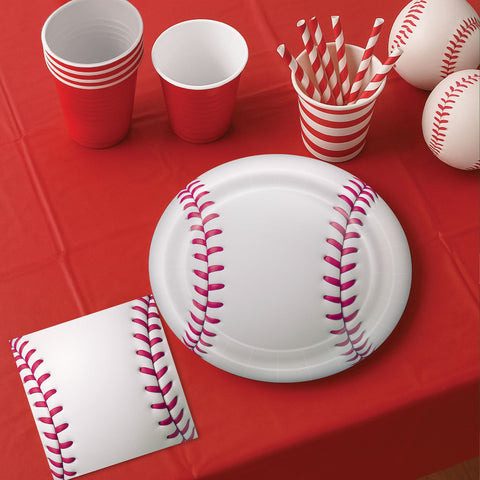 Baseball-themed party supplies including plates, on a red tablecloth.
